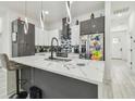 Stylish kitchen features stainless steel appliances, an island with seating, and modern pendant lights at 2305 W Kentucky Ave, Tampa, FL 33607
