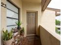 Balcony features a small seating area, plants, and shade from the sun at 3540 Countrybrook Ln # 23, Palm Harbor, FL 34684