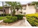 Exterior of the property features well maintained greenery around building with stairs to the unit at 3540 Countrybrook Ln # 23, Palm Harbor, FL 34684
