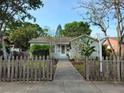Charming single-story home featuring a well-maintained lawn and inviting front porch and quaint picket fence at 3545 7Th N Ave, St Petersburg, FL 33713