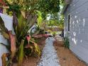 A picturesque view with white stone pathways and lush tropical plants and mulched area at 3545 7Th N Ave, St Petersburg, FL 33713