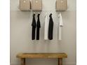 Organized walk-in closet with shelving, hanging rods, and bench at 3562 Silent Gardens Cv, Wesley Chapel, FL 33543