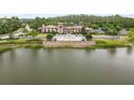 Beautiful aerial view of community clubhouse near the lake surrounded by trees and landscaping at 4365 Frontera Ln, Wesley Chapel, FL 33543