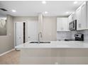 Bright kitchen showcasing white cabinets, modern appliances, and a sleek countertop for cooking at 4535 Winding River Way, Land O Lakes, FL 34639