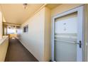 Hallway leading to unit shows door, carpeted floor and view of the water at 4550 Cove Cir # 502, St Petersburg, FL 33708