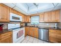 Kitchen features stainless steel appliances, granite countertops and light wood cabinets at 4550 Cove Cir # 502, St Petersburg, FL 33708