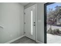 Bright entryway with a modern front door, stylish gray walls, and durable wood-look flooring at 5768 75Th N Ter, Pinellas Park, FL 33781