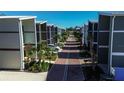 Modern townhomes line a brick street with palm trees, offering a stylish community setting and convenient parking at 5768 75Th N Ter, Pinellas Park, FL 33781