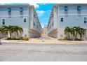 A street view showing the exterior of the homes with garages and complementary blue trim at 813 Burlington N Ave, St Petersburg, FL 33701