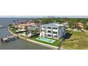 Modern waterfront property with pool and dock, surrounded by lush greenery and beautiful water views at 90 Martinique Ave, Tampa, FL 33606