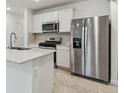 Close up of kitchen with stainless steel refrigerator and gas range with microwave above at 10418 Cross River Trl, Parrish, FL 34219