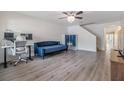 Comfortable living room showcasing wood floors, a couch, and a dedicated workspace at 10906 Keys Gate Dr, Riverview, FL 33579