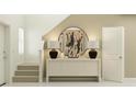 Hallway view with art display, lamps, stairs and tile flooring at 11738 Brae Way, Dade City, FL 33525