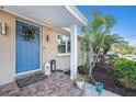 Close up of a charming front porch with brick steps and a stylish blue door at 1513 Owen Dr, Clearwater, FL 33759