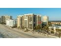 Beautiful condo building on the beach with a pool surrounded by palm trees at 1600 Gulf Blvd # 618, Clearwater, FL 33767