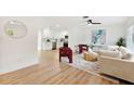 Bright living room featuring a plush sofa, modern decor, and open layout connecting to the kitchen at 1886 San Mateo Dr, Dunedin, FL 34698