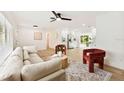 Bright living room featuring a plush sofa, modern decor, and an open layout connecting to the kitchen at 1886 San Mateo Dr, Dunedin, FL 34698