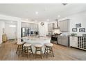 Bright kitchen featuring a center island with seating, stainless steel appliances and light grey cabinetry at 19629 Fort King Run, Brooksville, FL 34601