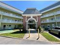The condo complex features light-yellow paint, white railings, and well-maintained landscaping at 2459 Columbia Dr # 17, Clearwater, FL 33763