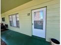 The unit's front door features a screen door and is painted white; the unit number is clearly displayed as '17' at 2459 Columbia Dr # 17, Clearwater, FL 33763