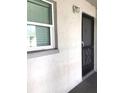 Exterior view of the front door with secure iron gate and storm door at 2625 State Road 590 # 1822, Clearwater, FL 33759