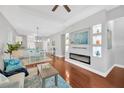 Open-concept living room with modern fireplace, hardwood floors, and recessed lighting at 3002 E 24Th Ave, Tampa, FL 33605