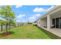 The backyard has a covered lanai and a view of the pond at 33581 Elm Hill Br, Wesley Chapel, FL 33545