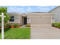 The exterior of this well-maintained home features a two-car garage and tasteful landscaping to enhance its curb appeal at 33581 Elm Hill Br, Wesley Chapel, FL 33545