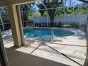 View from the lanai onto the screened-in pool, offering a seamless indoor-outdoor living experience at 3586 Culpepper Ter, North Port, FL 34286