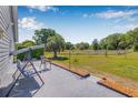 Serene backyard patio featuring a swing and spacious fenced-in yard with mature trees at 37434 Derbyshire Dr, Zephyrhills, FL 33542