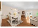 Inviting dining room featuring a chandelier, hardwood floors, and open-concept floor plan at 37434 Derbyshire Dr, Zephyrhills, FL 33542