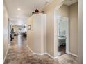 Inviting hallway with tiled floors leading to a cozy bedroom and other living areas, creating a warm ambiance at 4206 Morning Breeze Ct, Tampa, FL 33619