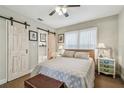 Cozy bedroom with barn door, soft lighting, and comfortable furnishings including a storage chest at 4462 2Nd S Ave, St Petersburg, FL 33711