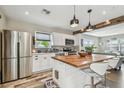 Modern kitchen features white cabinets, stainless steel appliances, wooden countertops, and pendant lighting at 4462 2Nd S Ave, St Petersburg, FL 33711