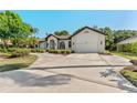 Beautiful white brick home with a well-manicured lawn and a spacious concrete driveway at 4677 Del Sol Blvd, Sarasota, FL 34243