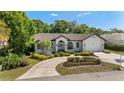 Well-maintained home featuring a circular driveway, lush landscaping, and a serene atmosphere at 4677 Del Sol Blvd, Sarasota, FL 34243