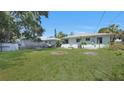 Spacious backyard featuring a lush lawn and partial fencing, offering ample room for activities at 5000 18Th S Ave, Gulfport, FL 33707
