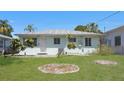 Backyard with green grass, garden beds, and a fence, perfect for outdoor enjoyment at 5000 18Th S Ave, Gulfport, FL 33707