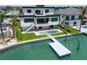 Waterfront home with private dock, inground spa, and outdoor dining area at 7974 1St S Ave, St Petersburg, FL 33707