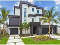 Modern home with a sleek design, black accents, and well-maintained landscaping at 7974 1St S Ave, St Petersburg, FL 33707