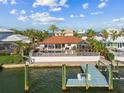 Aerial view of the waterfront home featuring a private pool, dock, and beautiful views of the surrounding water at 854 Harbor Is, Clearwater, FL 33767