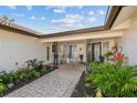 Charming front porch with rocking chairs, brick pavers, and a 'Welcome' sign, creating a cozy and inviting entrance at 854 Harbor Is, Clearwater, FL 33767
