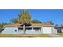 Inviting single-story home with a cozy front porch, perfect for relaxing outdoors at 1007 Greenleaf Way, Tarpon Springs, FL 34689