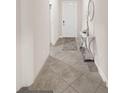 Bright foyer featuring tile flooring, a decorative table with mirror, and a view of the front door at 10628 Bahama Woodstar Ct, Riverview, FL 33579