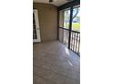 Tiled outdoor patio with screened enclosure and view to the outdoors at 11411 Pike Ct # 6, New Port Richey, FL 34654