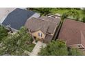 An aerial view of a home and community showcasing the pool, landscaping, and neighboring properties at 11607 Meridian Point Dr, Tampa, FL 33626