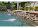 Close up of a pool with retaining wall featuring three individual streams of water flowing into the pool at 11607 Meridian Point Dr, Tampa, FL 33626