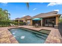 Inviting backyard featuring a brick-lined pool and spa, perfect for outdoor relaxation and entertaining at 11607 Meridian Point Dr, Tampa, FL 33626