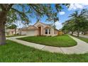 Attractive single-Gathering home on a well-kept lawn, showcasing its architectural design and landscaping at 11626 Pure Pebble Dr, Riverview, FL 33569