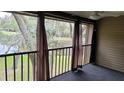 Screened in balcony with an idyllic water view and ceiling fan at 12041 Environmental Dr # 6, New Port Richey, FL 34654